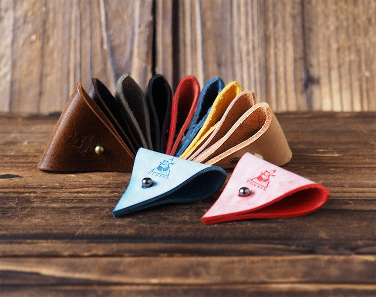 ES Corner Leather Cord Organizer 11 colors Blue Red on a wooden tray